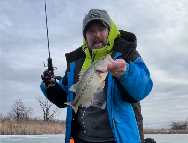 Ken holds a fish on hook