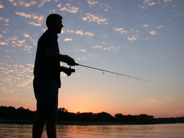 author's fishing body profile beside a lake