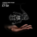A hand holding a black fishing reel with easy bite detection titanium tip and lightweight hybrid carbon fiber blank.
