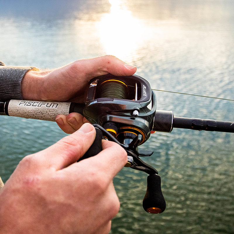 A person holding a Piscifun Alijoz Size 300 baitcasting reel, ready for a fishing adventure.